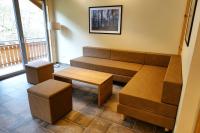 a living room with a couch and a table at Camping Bissen in Esch-sur-Sûre