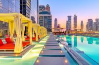 a hotel swimming pool with a view of a city at Canal Central Hotel Business Bay in Dubai