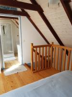 a attic room with a bed and a staircase at penty vero in Plobannalec-Lesconil
