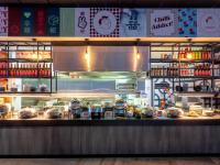 a restaurant with a counter with food on it at Ibis Styles Hobart in Hobart