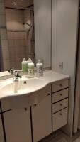 a bathroom with a sink and a mirror at Aalborg City Rooms ApS in Aalborg