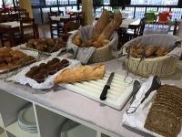 a table topped with baskets of bread and pastries at Paraiso del Sol y Paradero in Playa de las Americas