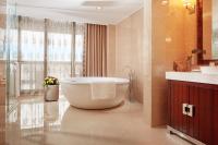 a bathroom with a tub and a sink at Beijing Hotel Minsk in Minsk