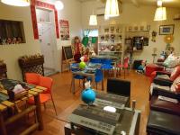 a woman in a room with tables and chairs at Yilan Real Fun Homestay in Dongshan
