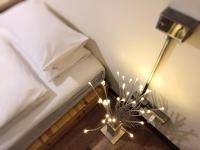 a bedroom with a bed and a lamp with lights at HomeStay LB in Taitung City