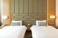 two beds sitting next to each other in a hotel room at Canal Central Hotel Business Bay in Dubai