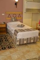 A bed or beds in a room at Marhaba Palace Hotel