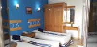 A bed or beds in a room at Marhaba Palace Hotel