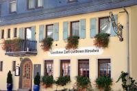 a building with flowers on the front of it at Gasthaus zum Goldenen Hirschen in Martinstein