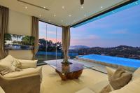 a living room with a large glass window at Magic suites Seaview villas, Koh Samui in Choeng Mon Beach