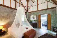 a bedroom with a bed with a mosquito net at Oon Lee Bungalows in Ko Jum