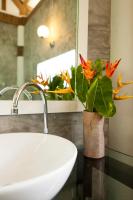 a bathroom with a sink and a vase with flowers at Oon Lee Bungalows in Ko Jum