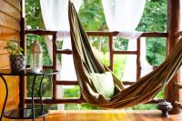 a hammock in a room with a window at Oon Lee Bungalows in Ko Jum