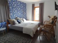 A bed or beds in a room at Sipos Borház és Vendégház