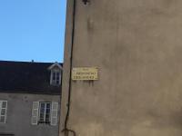 a yellow sign on the side of a building at Aux Cornettes in Beaune