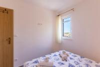 Postel nebo postele na pokoji v ubytování Apartmani Marinela
