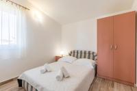 Postel nebo postele na pokoji v ubytování Apartmani Marinela