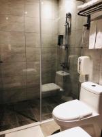 a bathroom with a toilet and a glass shower at Chance Hotel in Taichung