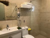 a bathroom with a toilet and a sink and a shower at Weiden House in Luodong