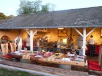 a pavilion with a table in front of a kitchen at Château De La Bourdaisière in Montlouis-sur-Loire