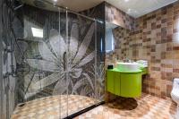 a bathroom with a shower with a sink and a toilet at Shichi Hotel in Kaohsiung