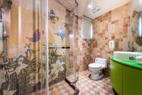 a bathroom with a shower with a toilet and a sink at Shichi Hotel in Kaohsiung