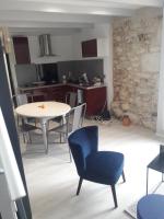 a kitchen and living room with a table and chairs at Taillefer in Saint Paul de Loubressac