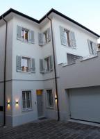 a large white building with a garage at OFFICINA TESINI Guest Rooms Verona in Verona