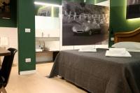 a bedroom with a bed and a picture of a car at OFFICINA TESINI Guest Rooms Verona in Verona