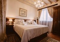 a bedroom with a bed with white sheets and a window at Heritage Hotel Cardo in Split