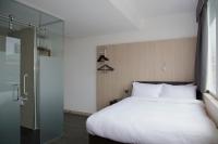 a bedroom with a bed and a glass shower at The Z Hotel Liverpool in Liverpool