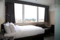 a hotel room with a bed and a chair and windows at The Z Hotel Liverpool in Liverpool