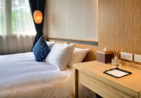 a hotel room with a bed and a table with a tray at Yunoyado Onsen Hot Spring Hotel -Xinyi Branch in Jiaoxi