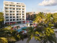 a view of a resort with a pool and palm trees at Boca Beach Residence hotel in Boca Chica
