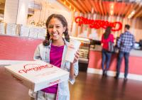 a young girl is holding a pizza box and a box at Circus Circus Reno, A Caesars Destination in Reno