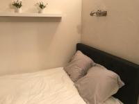 a bed with two white pillows in a room at Studio 2 pers en vieille ville parking gratuit - by La Source d&#39;OrFée in Boulogne-sur-Mer