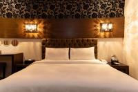 a bedroom with a large bed and two night stands at The Riverside Hotel Fashion in Kaohsiung