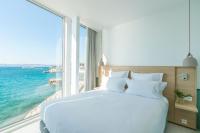 a bedroom with a large bed with a view of the ocean at Les Bords De Mer in Marseille