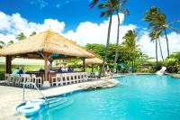 a swimming pool at a resort with a bar at OUTRIGGER Kaua'i Beach Resort & Spa in Lihue