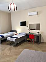 Posteľ alebo postele v izbe v ubytovaní Napoli City Inn