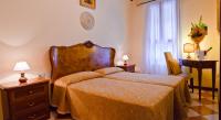 a bedroom with a bed and a table and a window at Hotel Henry in Venice