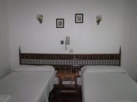 A bed or beds in a room at Hostal Esmeralda
