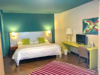 a bedroom with a bed and a desk with a computer at Hotel Ritual Torremolinos- Adults Only in Torremolinos