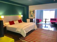 a bedroom with a bed with red pillows on it at Hotel Ritual Torremolinos- Adults Only in Torremolinos