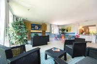 a lobby with chairs and a table and a room with a tableablish at Domaine La Pinède Enchantée in Argelès-sur-Mer