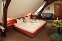 a bedroom with a large bed in a attic at Hotel Zur Fernmühle in Ziegenrück