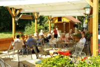 a group of people sitting at an outdoor restaurant at Hotel Zur Fernmühle in Ziegenrück