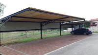 a parking lot with a car parked under a roof at Apartments Villa Adamović in Umag