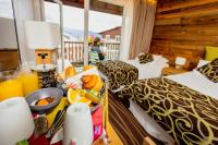 a room with two beds and a table with food on it at Le Grand Tétras in Font-Romeu