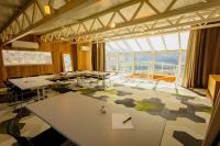 a conference room with tables and chairs and a large window at Le Grand Tétras in Font-Romeu